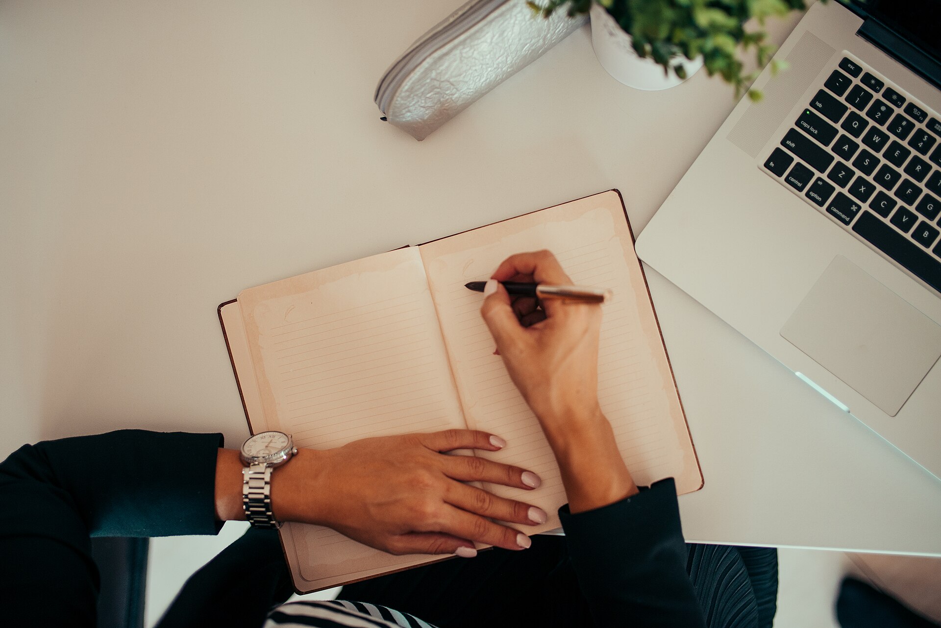Financial planning at a desk with notebook and laptop